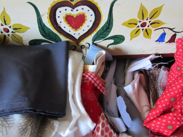 fabric bursting out of folk art dresser drawer